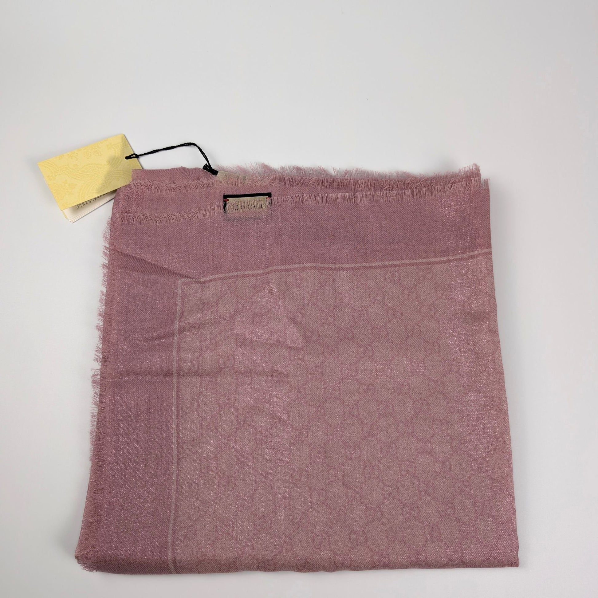 Scialle Gucci in lana GG jacquard rosa lucido piegato con cartellino originale
