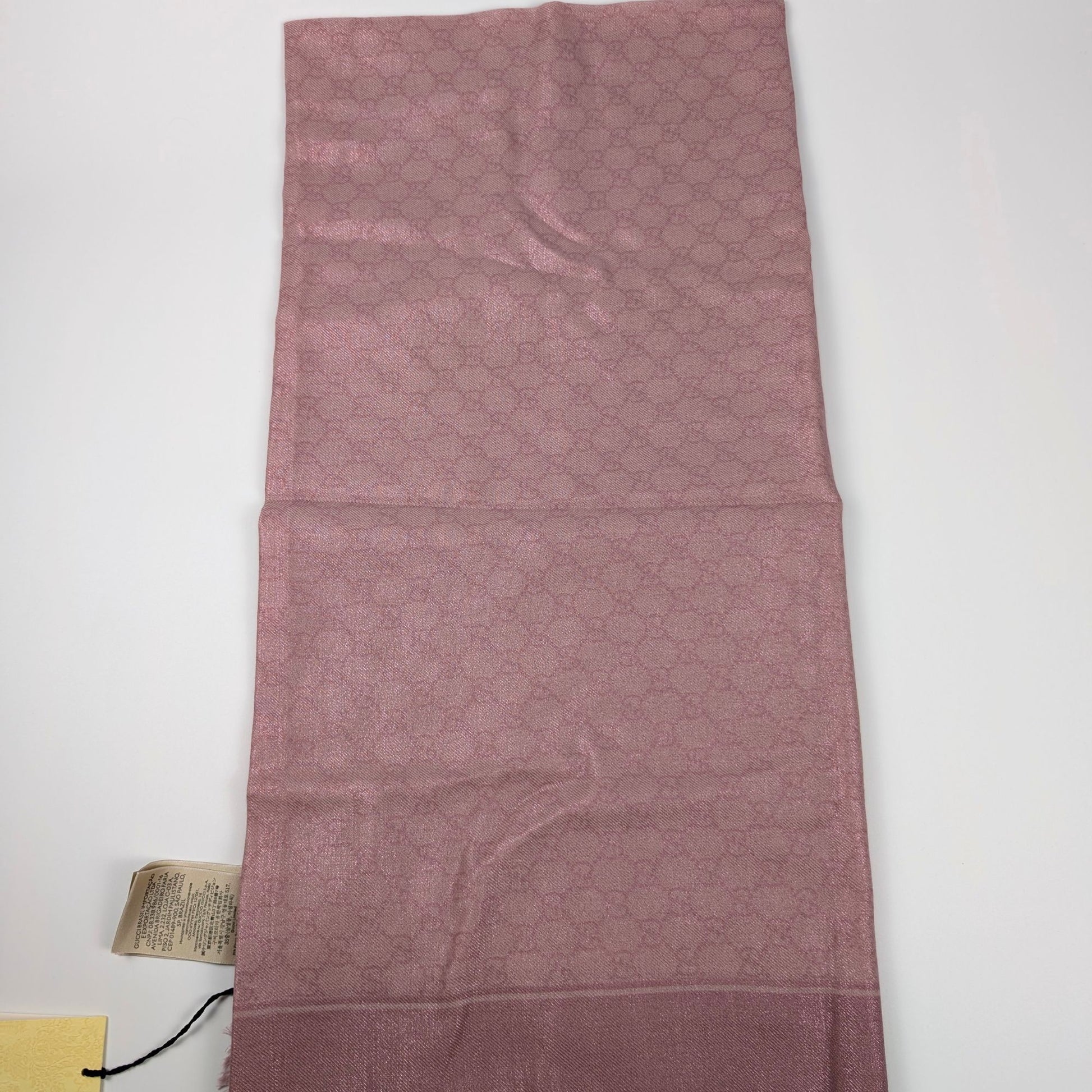 Scialle Gucci in lana GG jacquard rosa lucido piegato con cartellino originale
